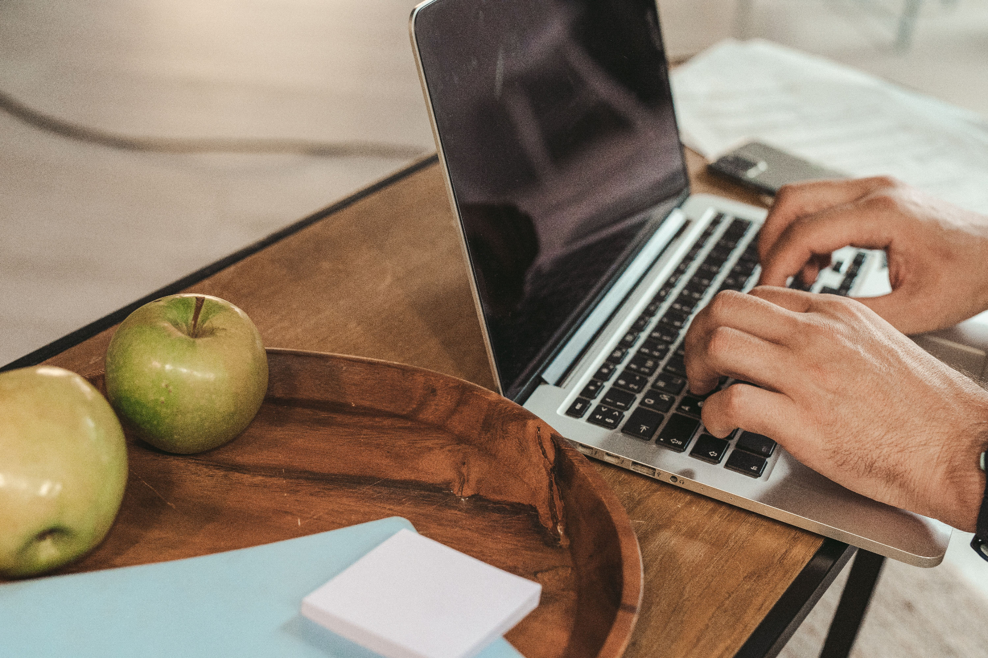 Person working on a MacBook in a Houston office